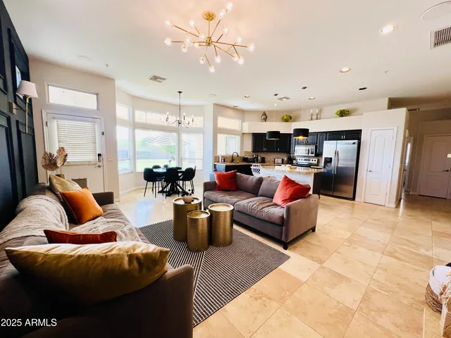 a living room with furniture and kitchen view