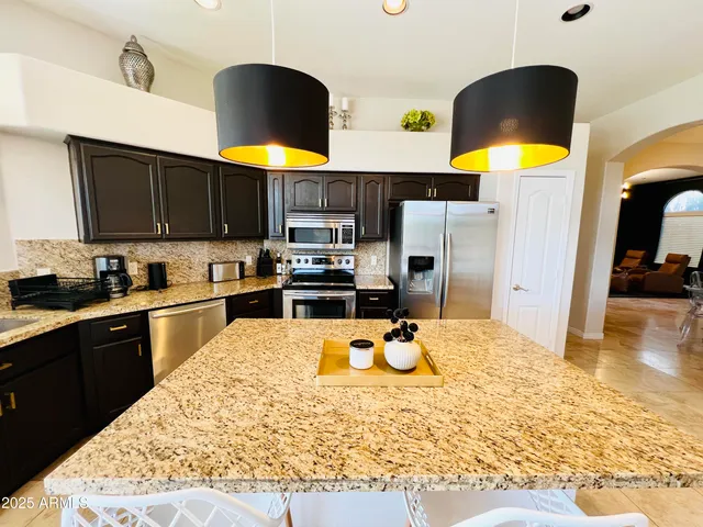 a kitchen with a stove refrigerator and a dining table