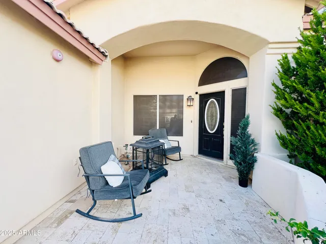 a front view of a house with outdoor seating