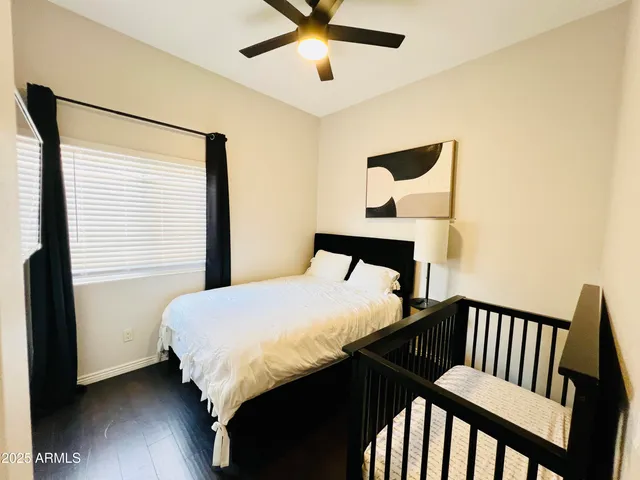 a bedroom with a large bed and a chandelier