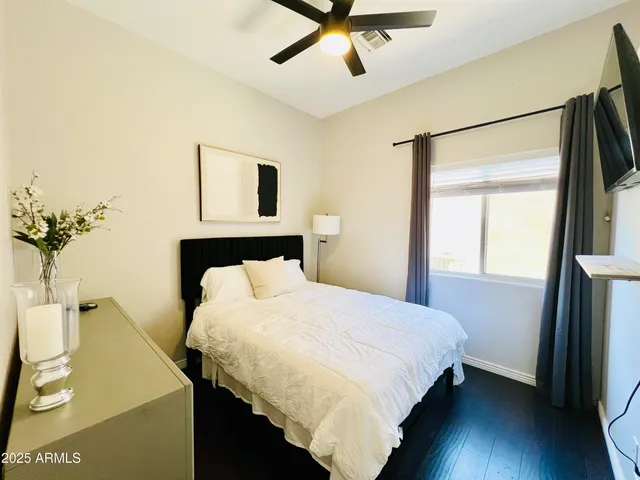 a bedroom with a bed and a flat screen tv