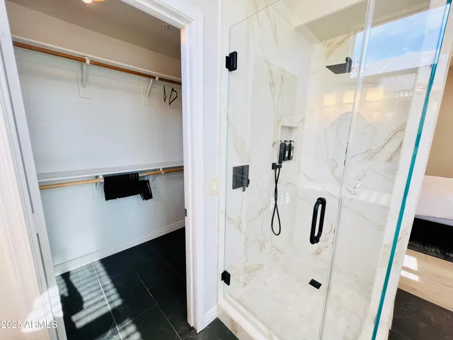 a bathroom with a granite countertop sink a toilet and a shower