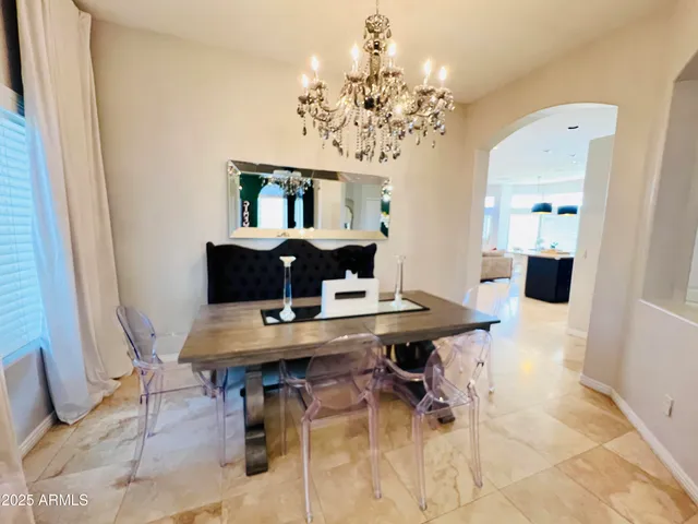 a view of a dining room with furniture and chandelier