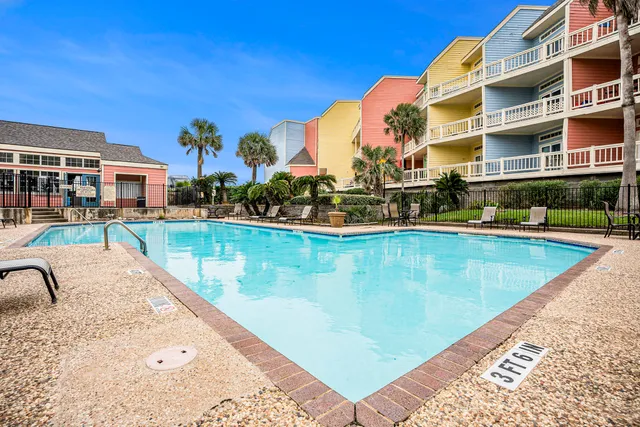 a view of a swimming pool with a lounge chairs