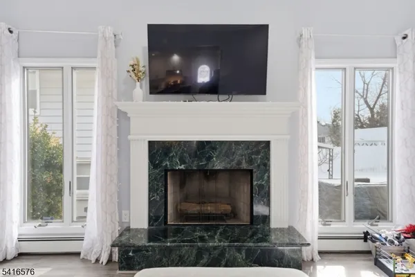 a living room with a fireplace and a flat screen tv