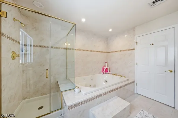 a bathroom with a tub and a shower