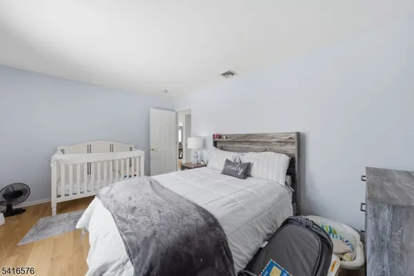 a bedroom with a bed and a chair