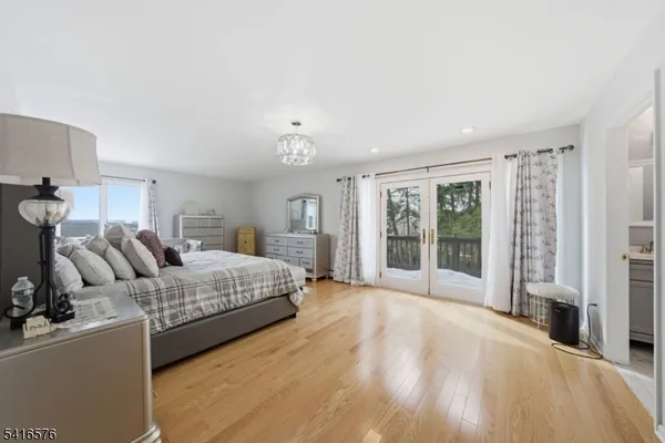 a spacious bedroom with a large bed and a window