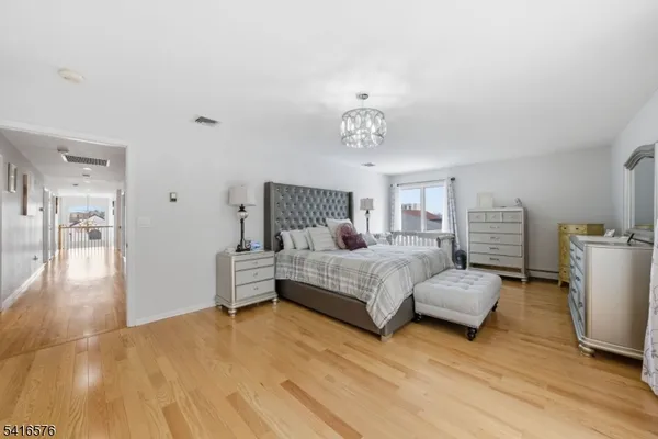 a bedroom with furniture and wooden floor