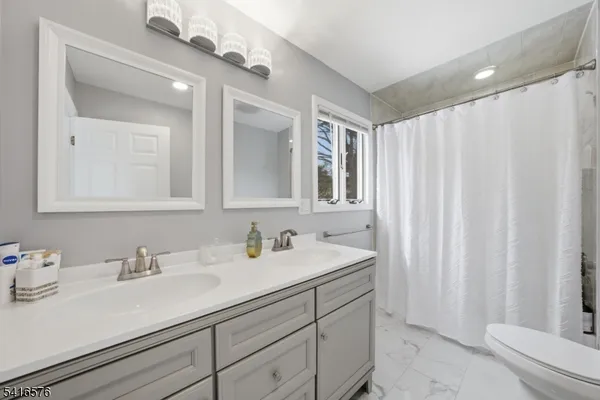 a bathroom with a double vanity sink and a mirror