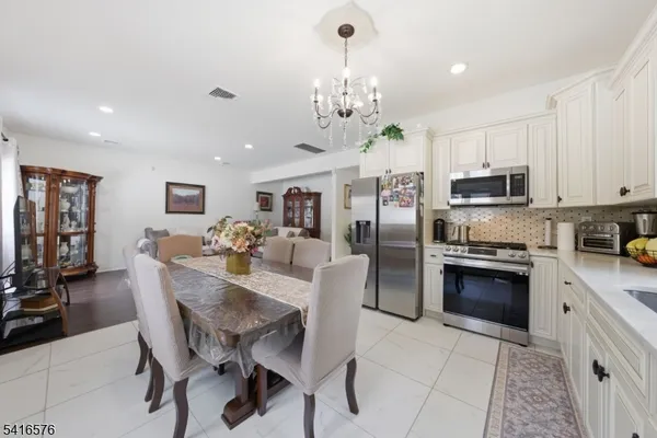 a view of kitchen with refrigerator stove microwave and cabinets