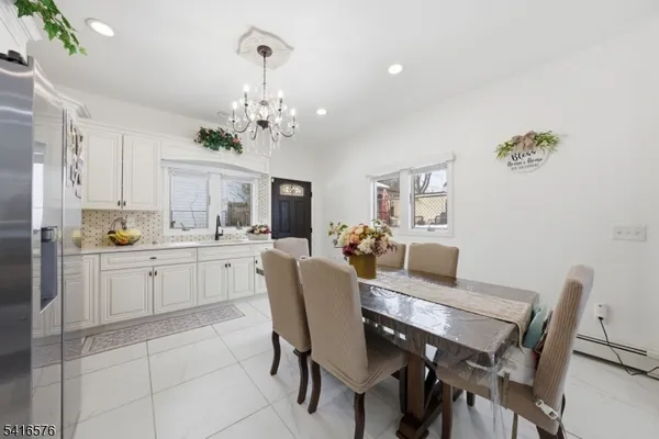 a view of a dining room with furniture and chandelier