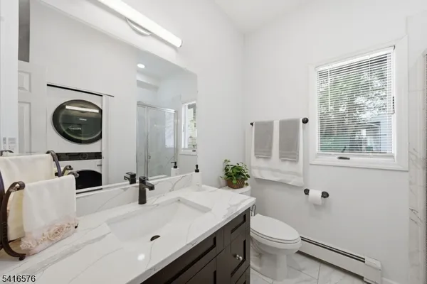 a bathroom with a sink a toilet and a mirror