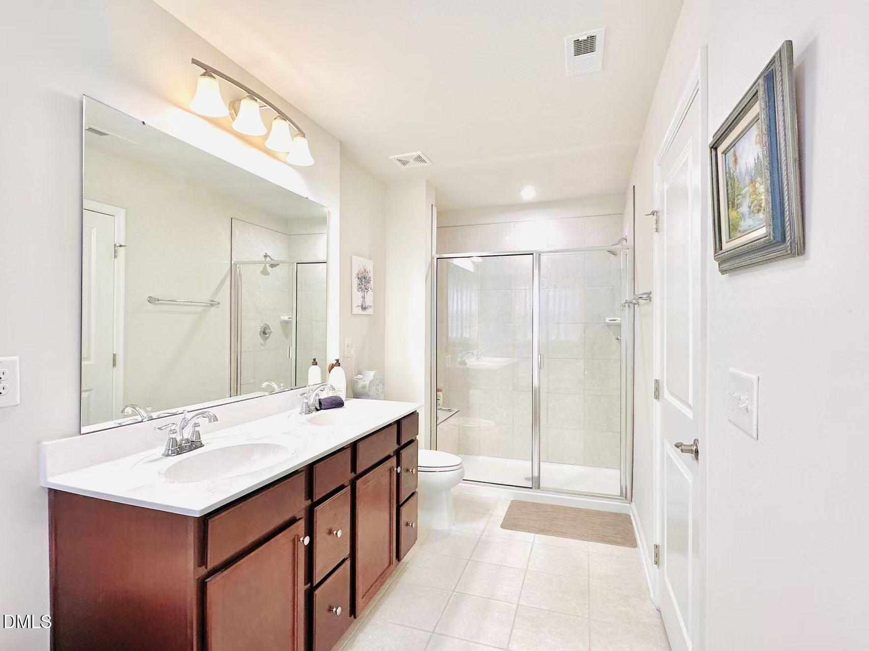 4740 Randall Road Durham, NC 27707 - Photo 11 of 29 a bathroom with a sink double vanity and a mirror