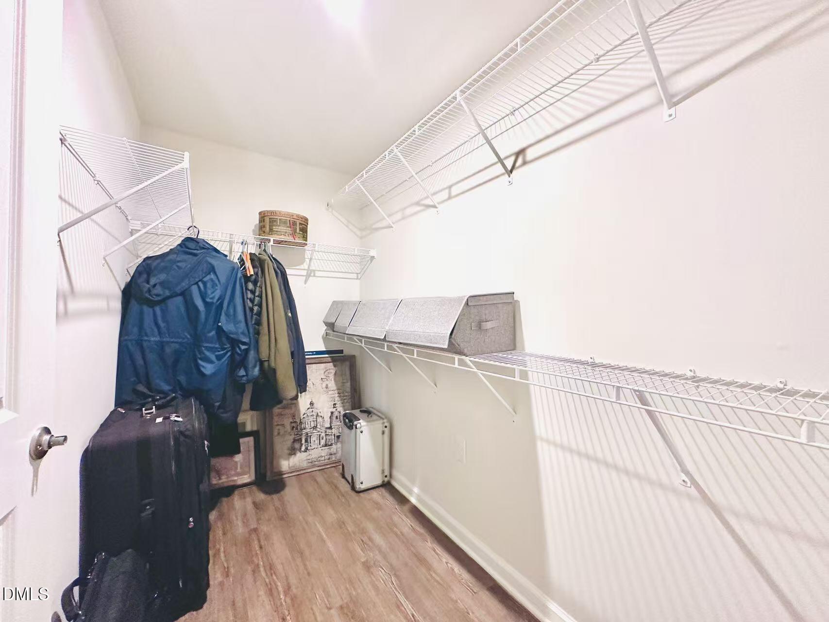 4740 Randall Road Durham, NC 27707 - Photo 13 of 29 a view of walk in closet with clothes and shoes