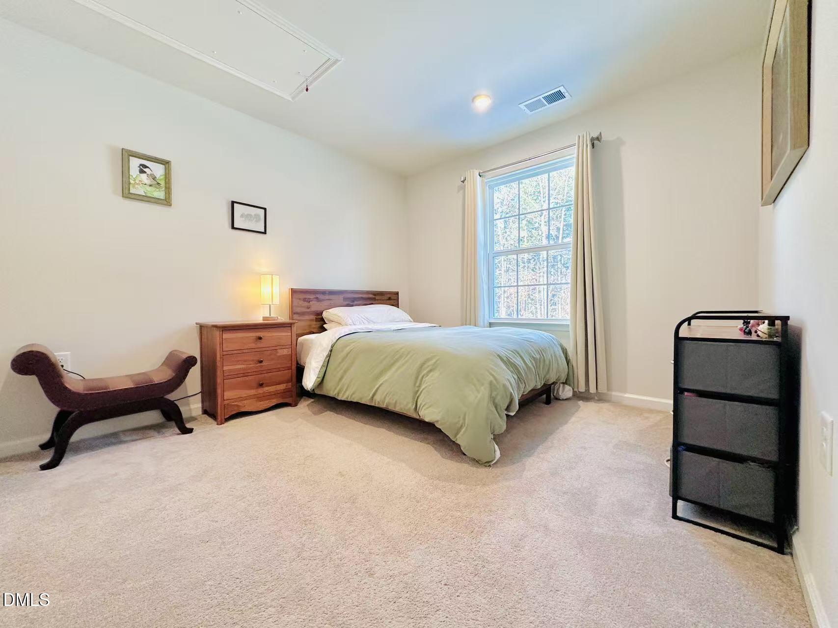 4740 Randall Road Durham, NC 27707 - Photo 14 of 29 a bedroom with a bed and a window