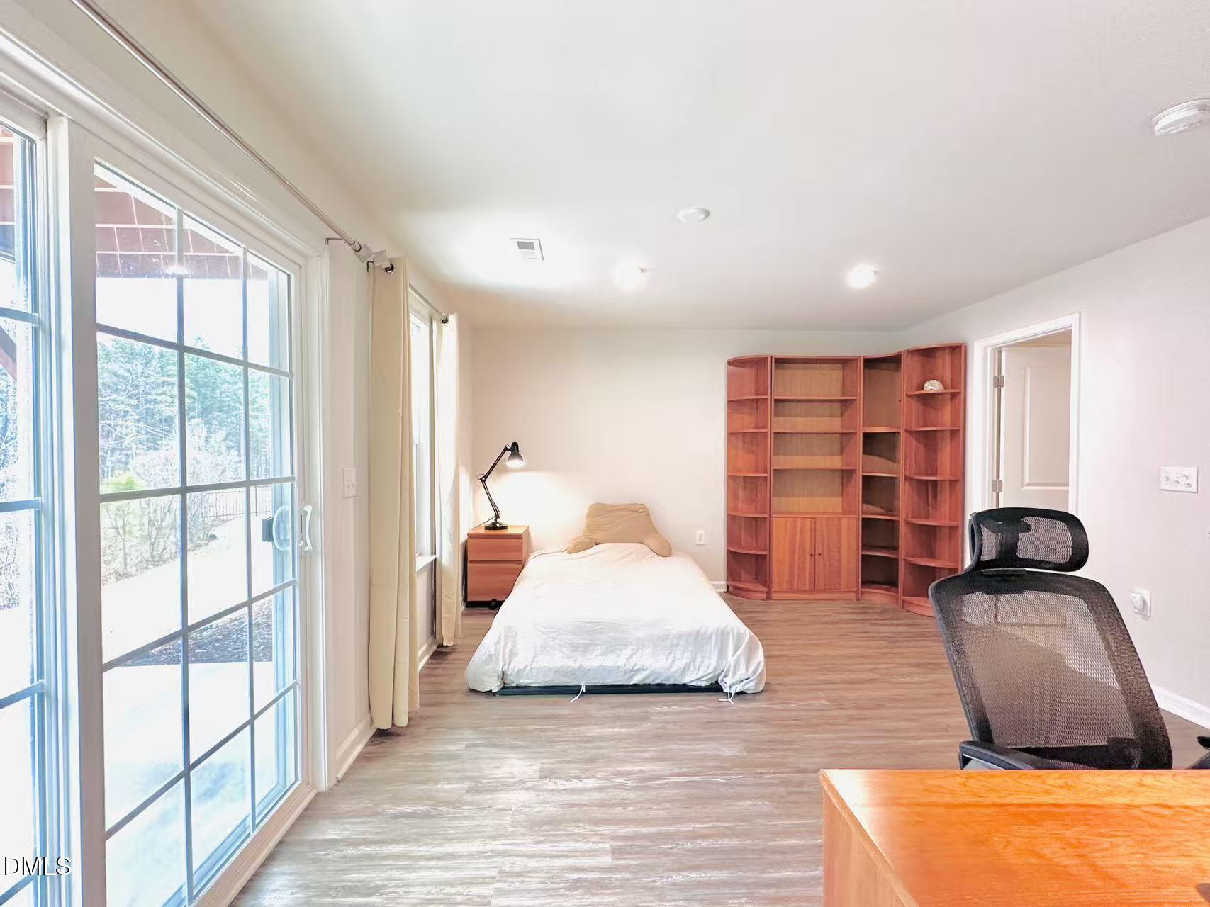 4740 Randall Road Durham, NC 27707 - Photo 17 of 29 a bedroom with furniture and a large window