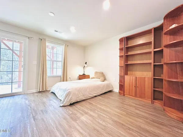 a spacious bedroom with a bed and a window