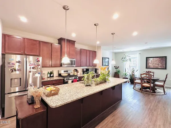 a kitchen with a sink refrigerator and cabinets