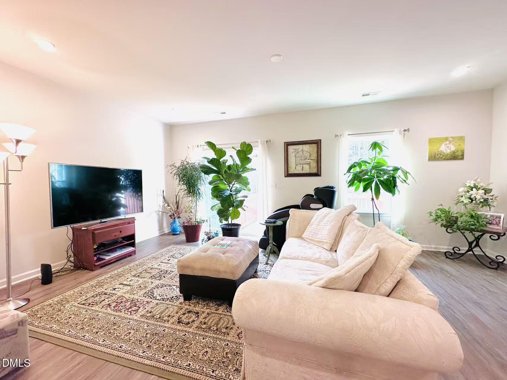 4740 Randall Road Durham, NC 27707 - Photo 5 of 29 a living room with furniture and a flat screen tv