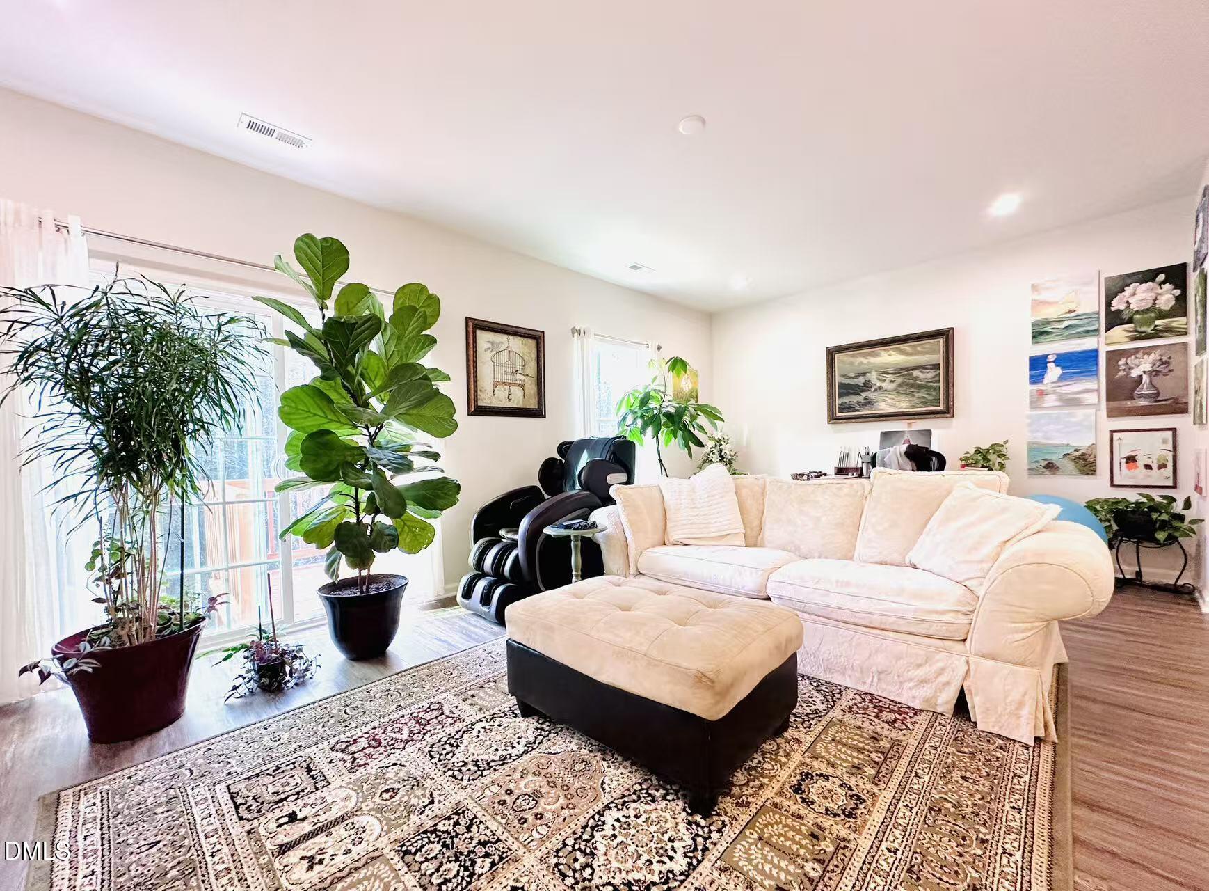 4740 Randall Road Durham, NC 27707 - Photo 6 of 29 a living room with furniture potted plant and a table