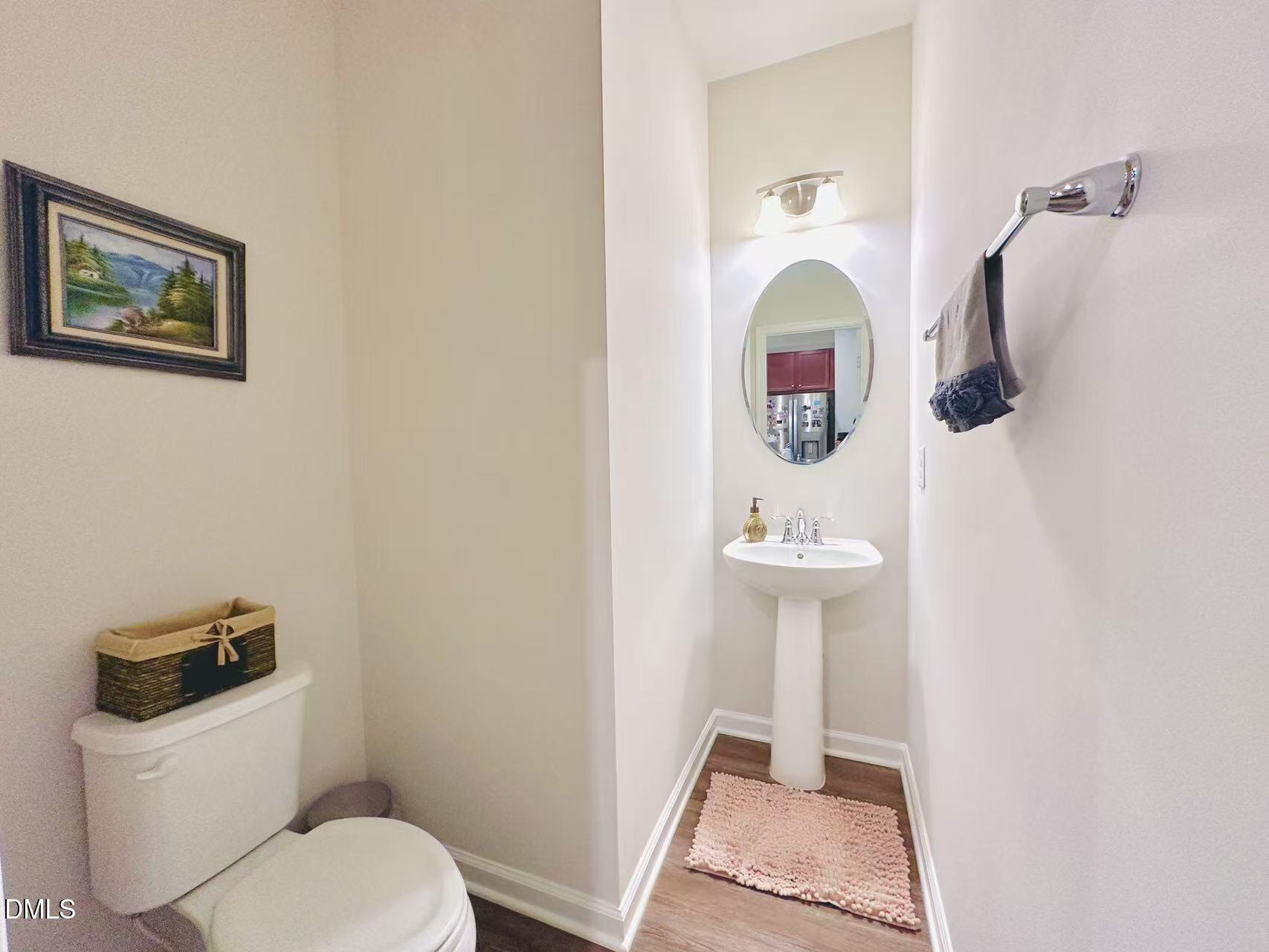 4740 Randall Road Durham, NC 27707 - Photo 9 of 29 a bathroom with a toilet a sink and mirror