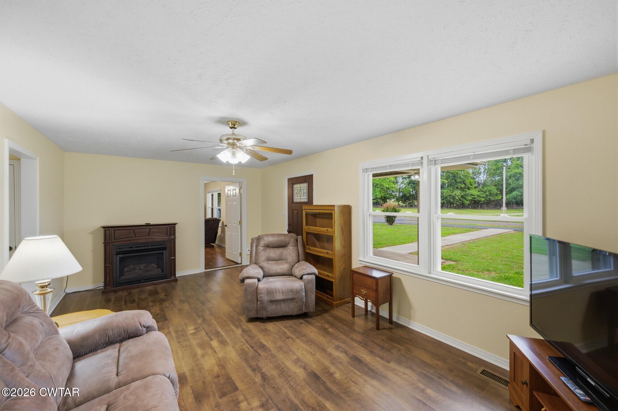 944 Brooksie Thompson Road Decaturville, TN 38329 - Photo 20 of 47 a living room with furniture a fireplace and a flat screen tv