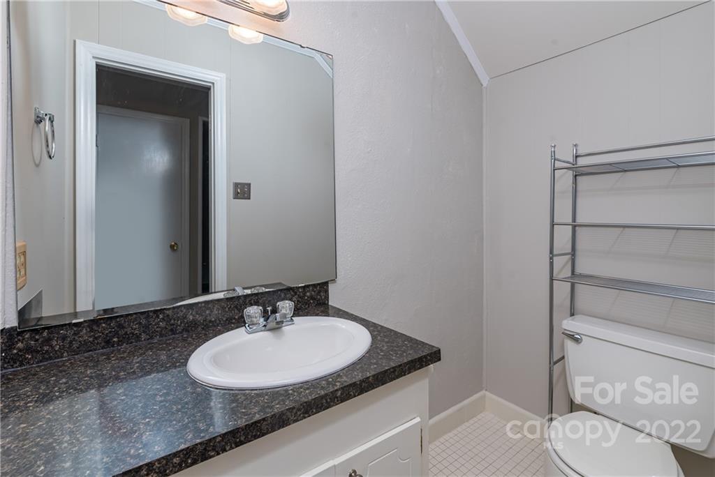 623 South New Hope Road, Unit 21 Gastonia, NC 28054 - Photo 12 of 18 a bathroom with a granite countertop sink and a mirror