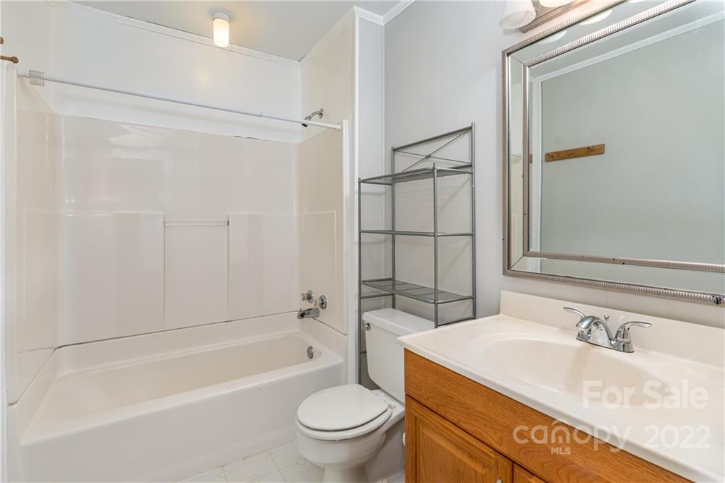 623 South New Hope Road, Unit 21 Gastonia, NC 28054 - Photo 18 of 18 a bathroom with a granite countertop sink toilet and shower