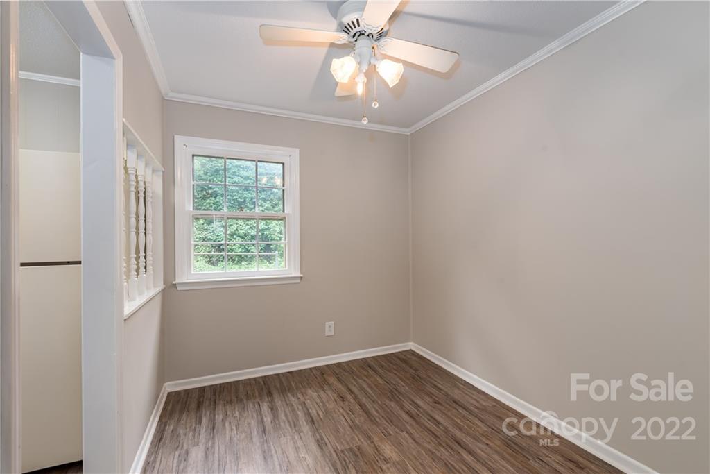 623 South New Hope Road, Unit 21 Gastonia, NC 28054 - Photo 5 of 18 an empty room with a window and wooden floor