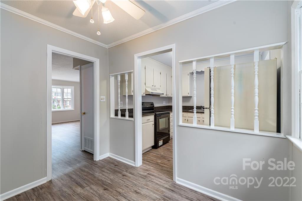 623 South New Hope Road, Unit 21 Gastonia, NC 28054 - Photo 7 of 18 a view of a kitchen with wooden floor and a refrigerator