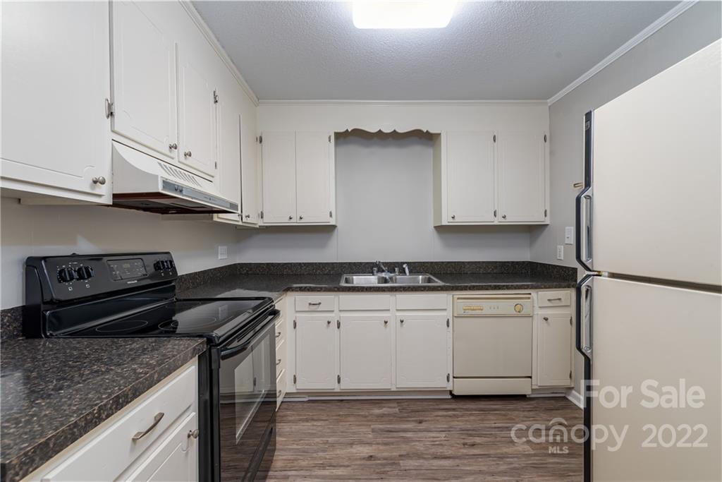 623 South New Hope Road, Unit 21 Gastonia, NC 28054 - Photo 8 of 18 a kitchen with stainless steel appliances granite countertop a sink stove and refrigerator