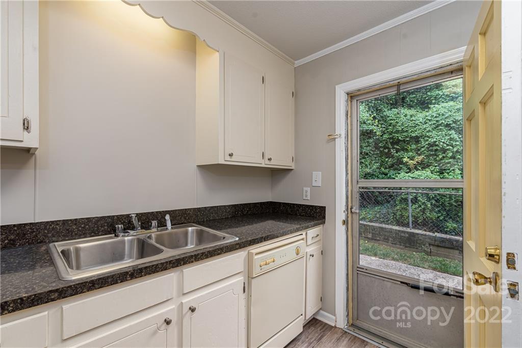 623 South New Hope Road, Unit 21 Gastonia, NC 28054 - Photo 10 of 18 a kitchen with granite countertop white cabinets and a sink