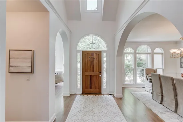 a kitchen with kitchen island granite countertop a sink a stove top oven a counter space and cabinets