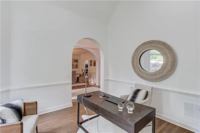 a kitchen with stainless steel appliances wooden floor dining table and chairs
