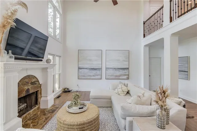a living room with furniture a large window and a flat tv screen