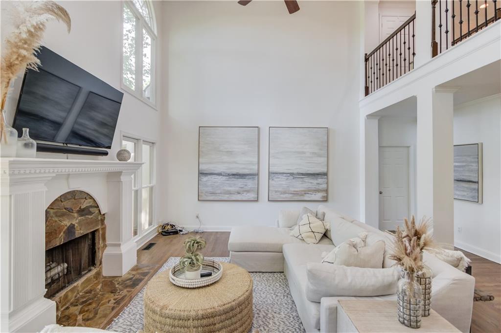2870 Roanoke Road Cumming, GA 30041 - Photo 18 of 94 a living room with furniture a fireplace and a flat screen tv