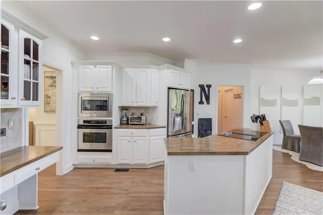 a view of entryway livingroom and hall with wooden floor