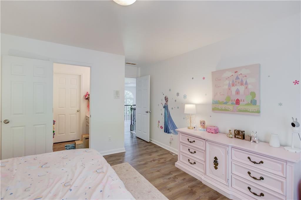 2870 Roanoke Road Cumming, GA 30041 - Photo 44 of 94 a bedroom with a bed and a dresser in it