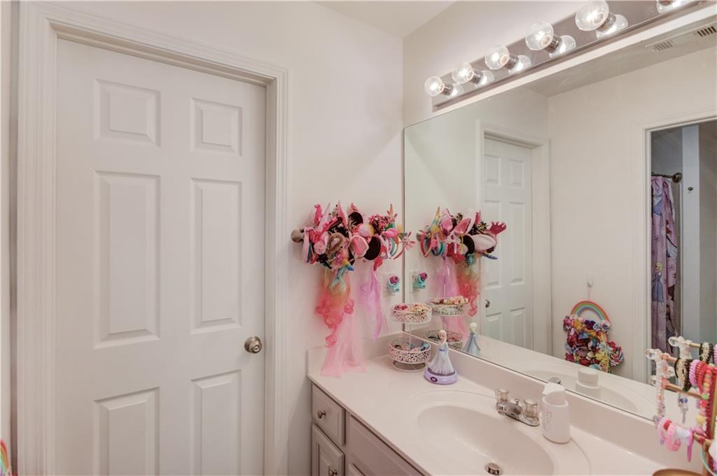 2870 Roanoke Road Cumming, GA 30041 - Photo 45 of 94 a bathroom with a sink vanity and a mirror