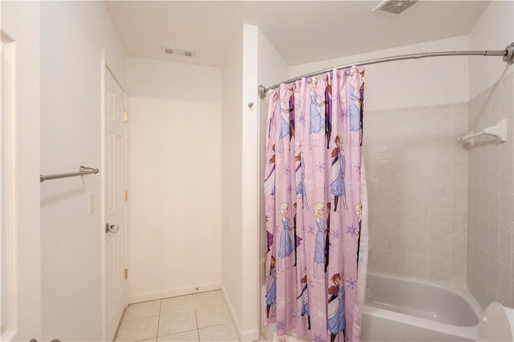 2870 Roanoke Road Cumming, GA 30041 - Photo 46 of 94 a bathroom with a shower curtain and a shower curtain