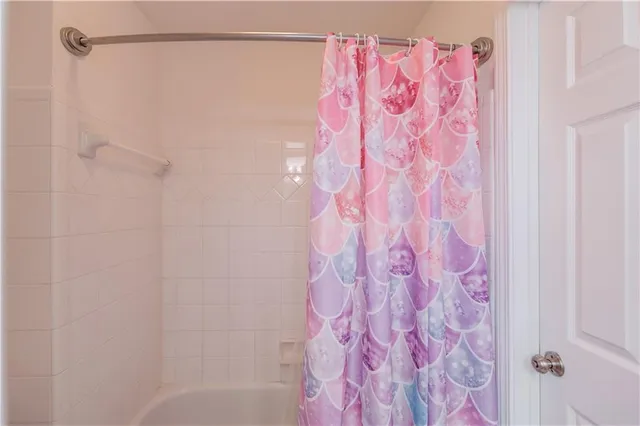 a view of a patio with couches chairs and a table and chairs with wooden fence