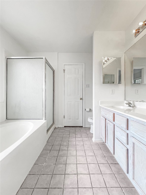 3700 Pevetoe Street Austin, TX 78725 - Photo 13 of 14 Bathroom with a garden tub, vanity, light tile patterned floors, and a stall shower