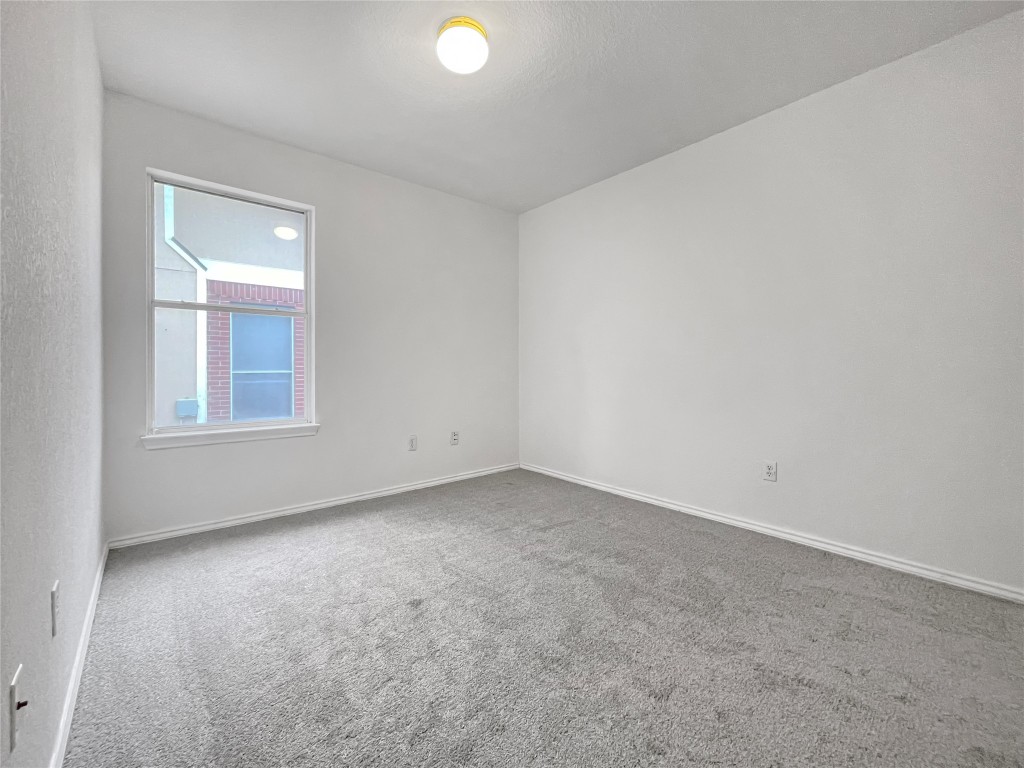 3700 Pevetoe Street Austin, TX 78725 - Photo 6 of 14 Carpeted spare room featuring baseboards