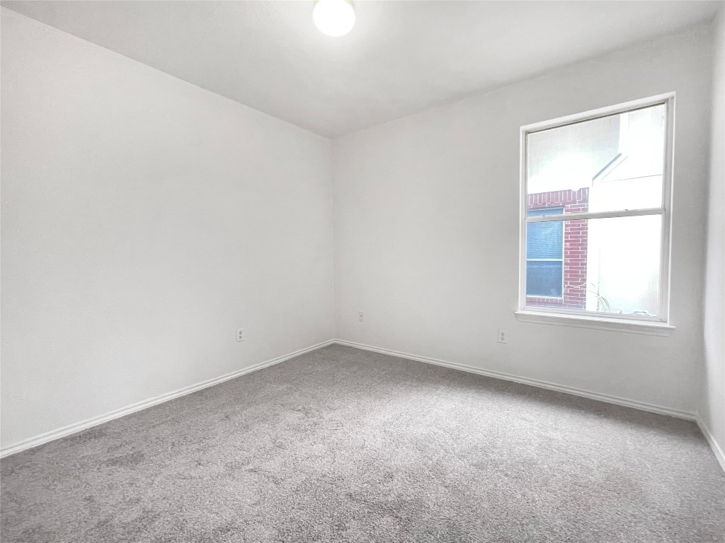3700 Pevetoe Street Austin, TX 78725 - Photo 8 of 14 Spare room with carpet flooring and baseboards