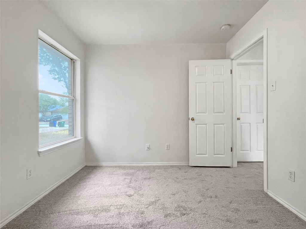 3700 Pevetoe Street Austin, TX 78725 - Photo 9 of 14 Unfurnished bedroom featuring light colored carpet and baseboards