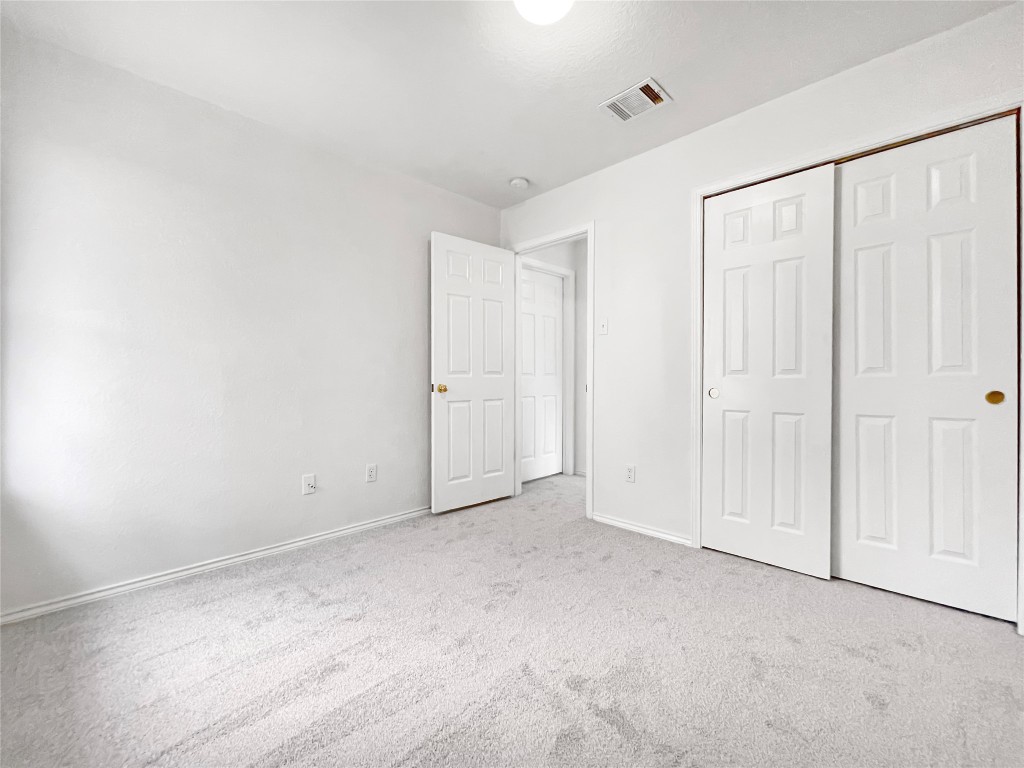 3700 Pevetoe Street Austin, TX 78725 - Photo 10 of 14 Unfurnished bedroom with a closet and carpet flooring