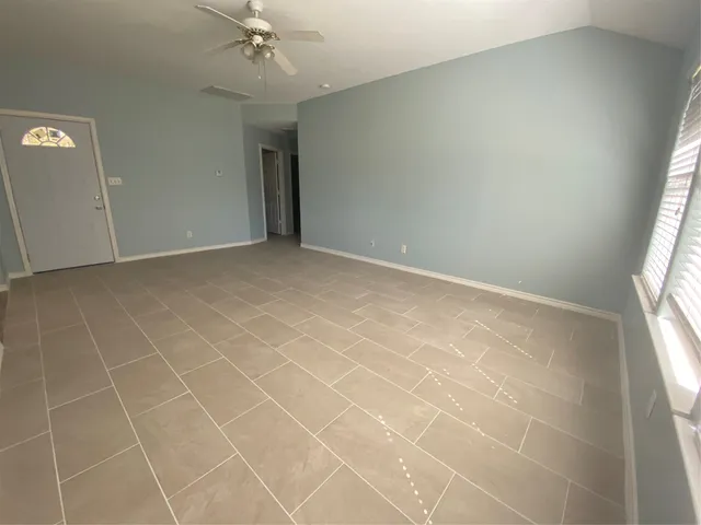 an empty room with a empty space and windows