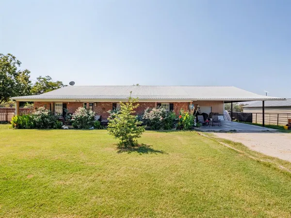 a front view of house with yard and seating area