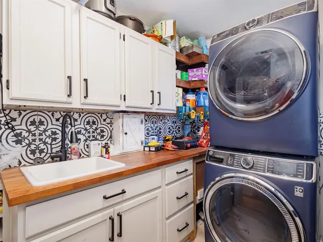 a utility room with sink dryer and washer